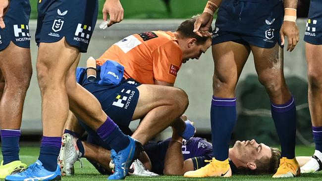 Ryan Papenhuyzen lies on the ground after hurting his knee. Picture: Quinn Rooney/Getty Images