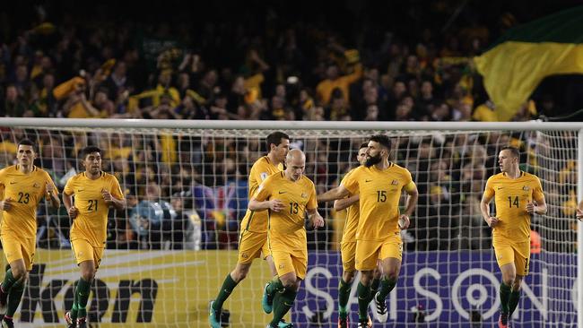 Socceroos players run back after Mile Jedinak of Australia scored a goal.