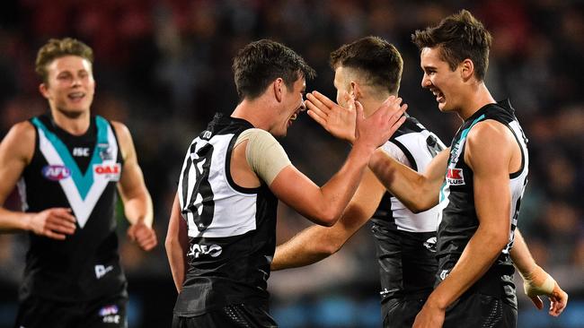 Power rookie Connor Rozee, right, celebrates a goal with Zak Butters, Robbie Gray and Xavier Duursma. Picture: Daniel Kalisz/Getty Images