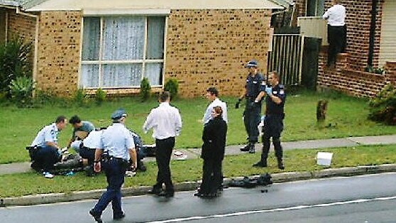 Police pin terrorist suspect Omar Baladjim to the ground on Eilson Rd in Green Valley near Bonnyrigg after he was shot while being arrested during raids in 2005. Picture: The Australian