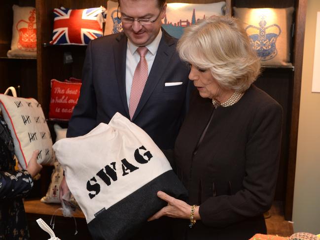 Swags and pelmets ... Camilla, Duchess of Cornwall, inspects cushions made by prisoners from the Fine Cell Work project at the Fortnum &amp; Mason department store in London.