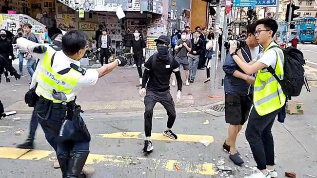 A video grab taken from Cupid News on November 11 shows a policeman shooting a pro-democracy protester in the chest in the Sai Wan Ho district. Picture: Cupid News