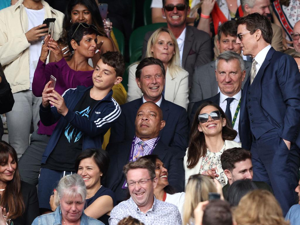 Tom Cruise poses for a selfie with a young fan.