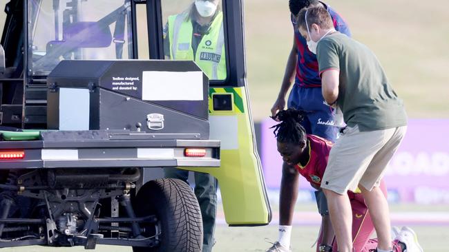 Shamilia Connell is helped to her feet after collapsing. (Photo by MICHAEL BRADLEY / AFP)