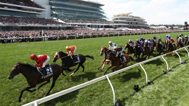 The field makes its way down the home straight on the first occasion. Picture: Getty Images