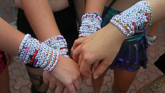 "Swifties", show off their friendship bracelets gather outside Accor Stadium/