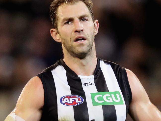MELBOURNE, AUSTRALIA - JULY 02: Travis Cloke of the Magpies takes off his glove at the end of the game during the round 15 AFL match between the Carlton Blues and the Collingwood Magpies at Melbourne Cricket Ground on July 2, 2016 in Melbourne, Australia. (Photo by Quinn Rooney/Getty Images)