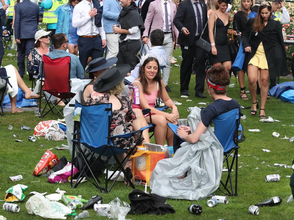 Racegoers are seen at the end of the day in Melbourne. Picture: AAP Image/Dave Crosling