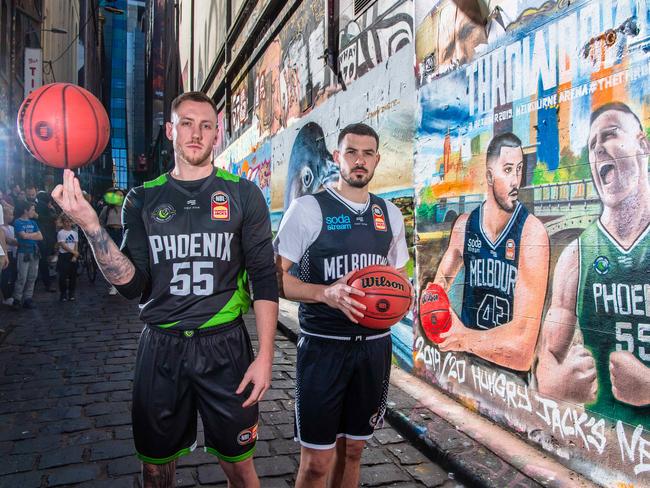Melbourne United's Chris Goulding (right) and South East Melbourne Phoenix's Mitch Creek.The 2019/20 Hungry Jack's NBL Season tips off this Thursday October 3 when Melbourne United plays new crosstown rival South East Melbourne Phoenix in the inaugural Throwdown. Unveiling of a special mural to mark the inaugural Throwdown between Melbourne United and South East Melbourne Phoenix in Hosier Lane, Melbourne VIC. Picture: Jason Edwards