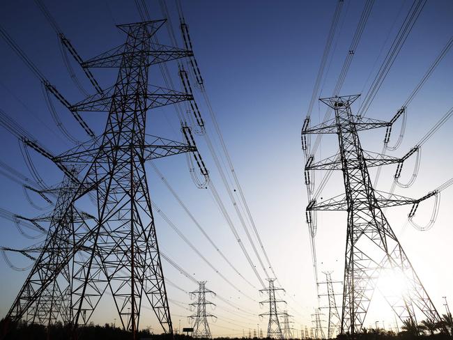 The sun sets behind overhead power lines as the Kuwaiti Ministry of Electricity requested citizens to ration their electricity usage at peak times due to outages caused by the increased pressure on power stations amid soaring temperatures and heightened energy demand, in Kuwait City on June 19, 2024. (Photo by YASSER AL-ZAYYAT / AFP)