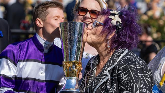 James McDonald and Riff Rocket part-owner Debbie Kepetis kiss the Victoria Derby trophy. Picture: Jay Town/Racing Photos via Getty Images