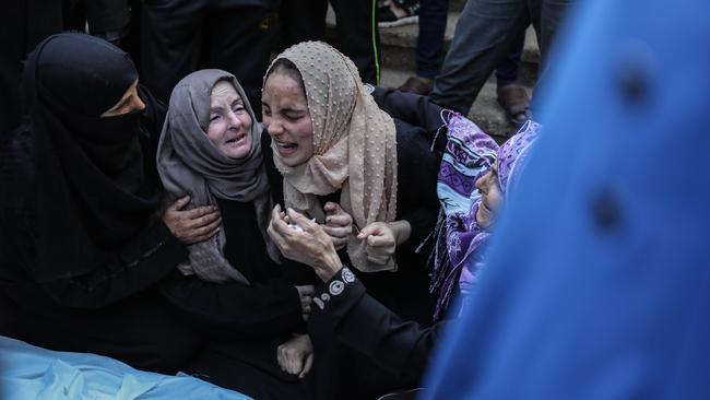 Two women mourn the death of family members. Picture: AFP