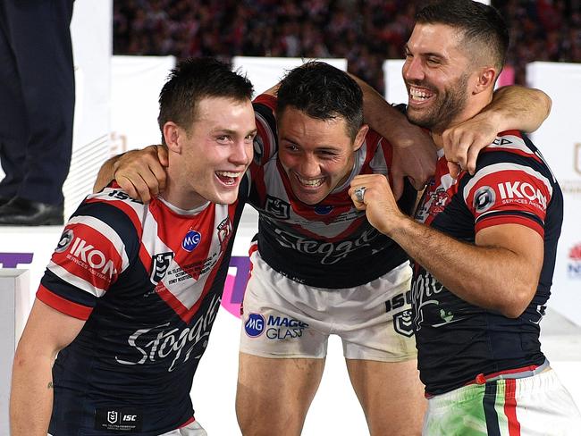 Luke Keary, Cooper Cronk and James Tedesco of the Roosters celebrate following their win over the Raiders in the 2019 NRL Grand Final between the Canberra Raiders and the Sydney Roosters at ANZ Stadium in Sydney, Sunday, October 6, 2019. (AAP Image/Dan Himbrechts) NO ARCHIVING, EDITORIAL USE ONLY