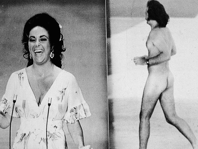 Elizabeth Taylor laughs as she remarks that she was upstaged by streaker Robert Opal before presenting the Oscar for Best Picture at the 46th Annual Academy Awards ceremony, Los Angeles, California, April 2, 1974. At right, Opal darts across the stage naked just as David Niven was introducing Taylor. (Photo by Hulton Archive/Getty Images)