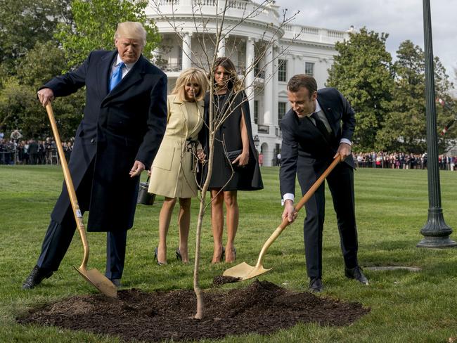 First lady Melania Trump, second from right, and Brigitte Macron, second from left, watch as President Donald Trump and French President Emmanuel Macron participate in a tree planting ceremony on the South Lawn of the White House. Picture: AP