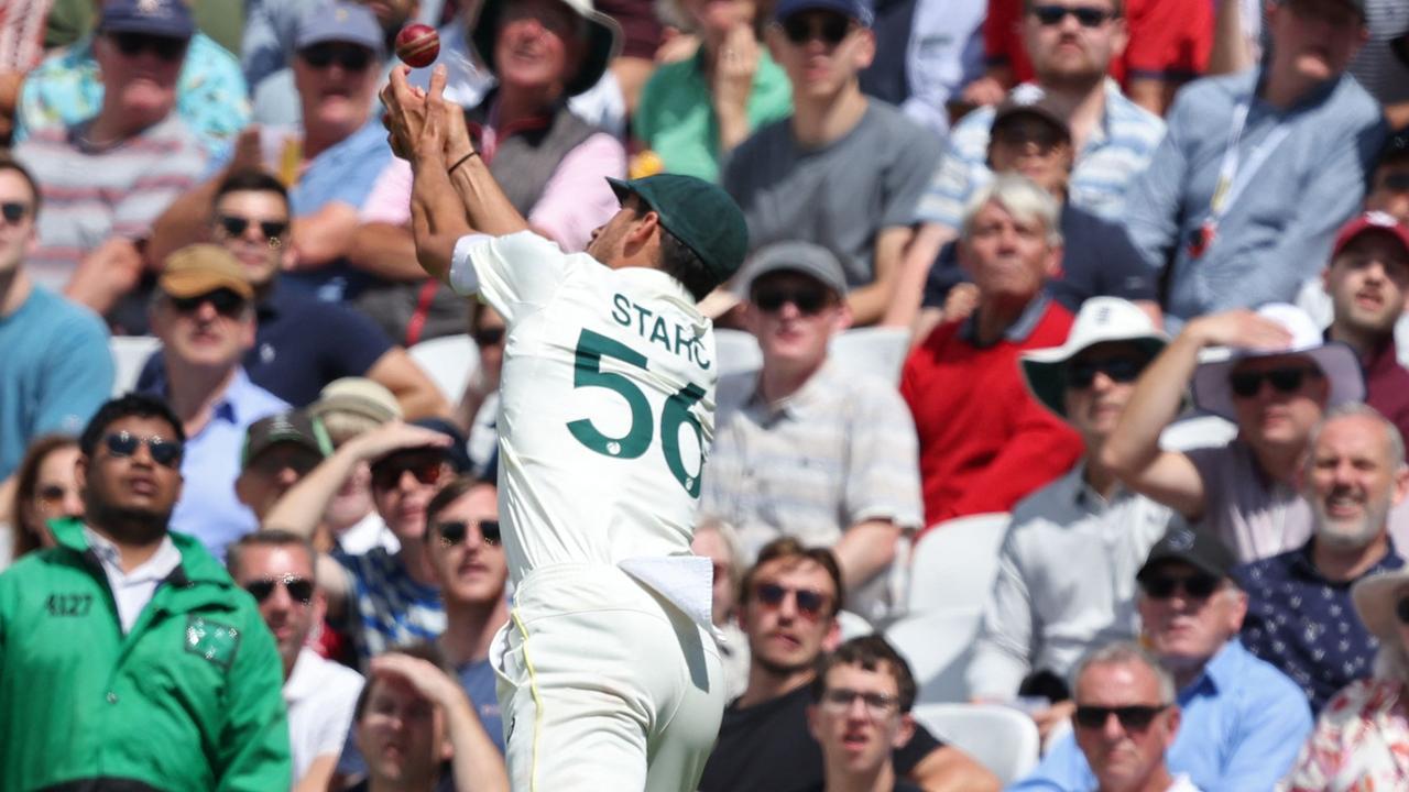 Starc attempts to catch the ball on the rope. (Photo by Adrian DENNIS / AFP)