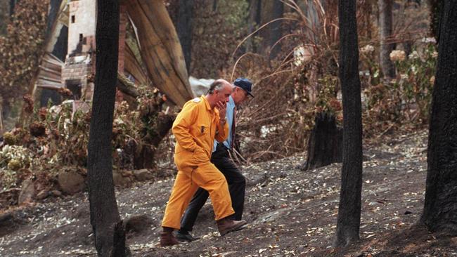 CFA Chiefs inspecting fire damage in Seabreeze Ave, Ferny Creek in 1997.