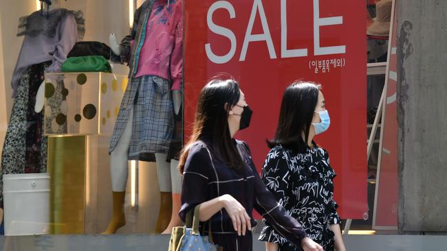 Shoppers walk along Myeongdong shopping district in Seoul last week. Picture: AFP