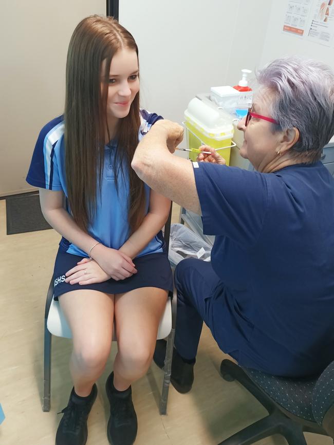 Moranbah State High School student Jessie Earl and nurse Sue Farrell at the Moranbah vaccination clinic.