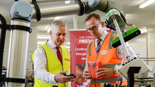 Redarc managing director Anthony Kittel, left, and AMGC managing director Dr Jens Goennemann inspect a ‘collaborative’ robot at the Lonsdale facility. Picture: Brenton Edwards