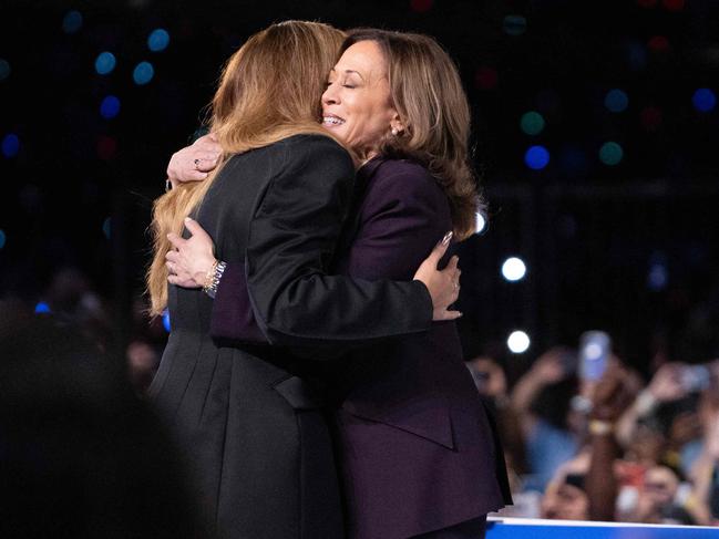 TOPSHOT - US Vice President and Democratic presidential candidate Kamala Harris (R) embraces US singer-songwriter Beyonce onstage during a campaign rally at Shell Energy Stadium in Houston, Texas, on October 25, 2024. (Photo by ROBERTO SCHMIDT / AFP)