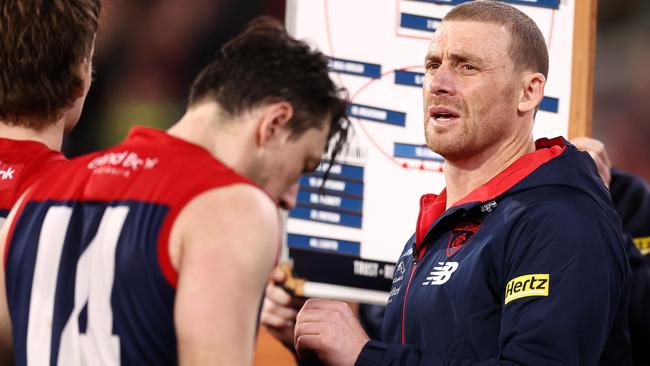 Simon Goodwin searches for answers at the three-quarter huddle. Picture: Michael Klein