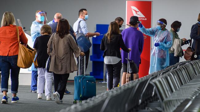 Passengers undergo a health screening at Melbourne airport. Picture: Jay Town