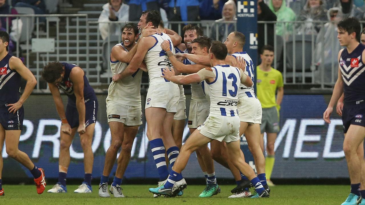 Todd Goldstein of the Kangaroos is congratulated by team mates after kicking a goal against Fremantle. (Photo by Paul Kane/Getty Images)