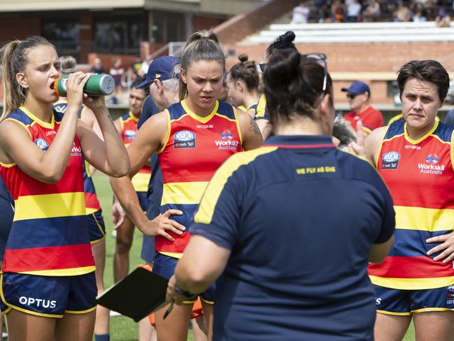 AFLW Crows forwards Danielle Ponter, Anne Hatchard and Courtney Gum listen to assistant coach Narelle Smith during break in play. Picture: AAP/EMMA BRASIER