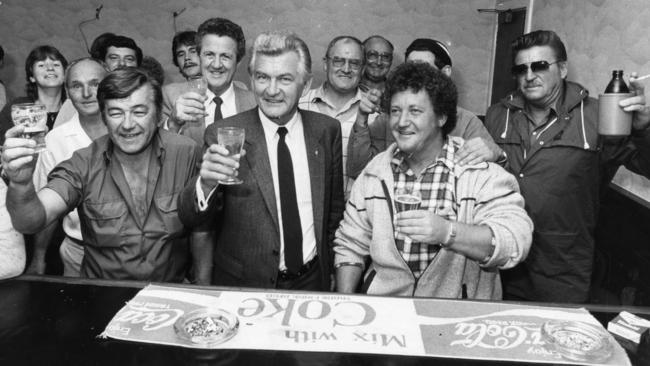 Prime Minister Bob Hawke shouts the bar at the Colac Hotel during an unscheduled stop on his visit to Adelaide in April 1984. Hawke is pictured with his glass of soda with Special Minister of State Mick Young on his right at the back.