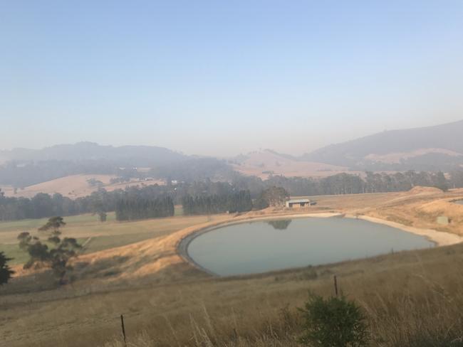 Bushfire smoke hangs over the Huon Valley, south of Hobart, sparking an alert from the Tasmania Fire Service. Picture: DAVID KILLICK