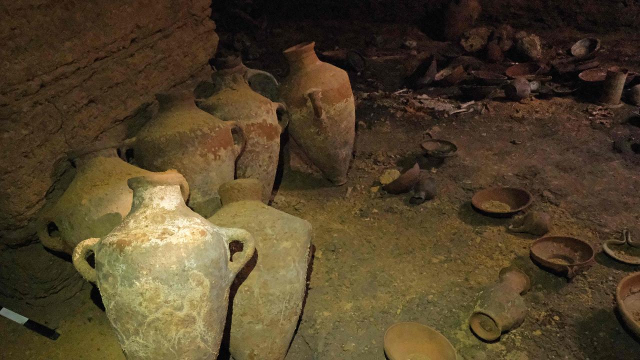 Archaeologists used a ladder to descend into the spacious, man-made square cave. Picture: Emil Aladjem/Israeli Antiquities Authority/AFP