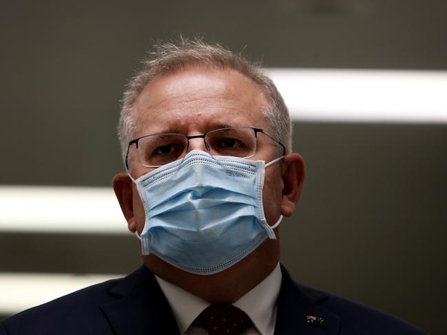 SYDNEY, AUSTRALIA - AUGUST 19: Prime Minister Scott Morrison is seen wearing a face mask during a press conference at AstraZeneca on August 19, 2020 in Sydney, Australia.  The Australian government has announced an agreement with the British pharmaceutical giant AstraZeneca to secure at least 25 million doses of a COVID-19 vaccine if it passes clinical trials.  The University of Oxford COVID-19 vaccine is currently in phase-three testing. If the vaccine proves to be successful, Australia will manufacture and supply vaccines and will be made available for free. The project could deliver the first vaccines by the end of this year or by early 2021. (Photo by Lisa Maree Williams/Getty Images)