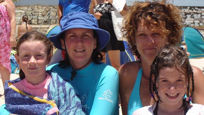 Escaping the heat at Coolum Beach are Sophie and Elaine Moore with Vicky and Jordan Atkins in 2005.