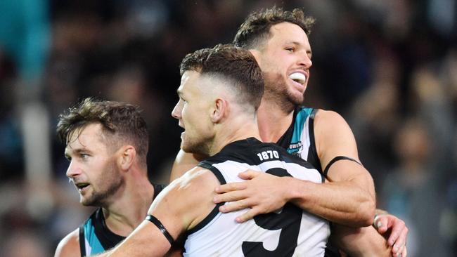 Robbie Gray of the Power celebrates a goal with Sam Gray and Travis Boak. Picture: AAP Image/David Mariuz                        <a capiid="2097afaeb409ab52e463f997046d5691" class="capi-video">Late Power surge seals derby</a>