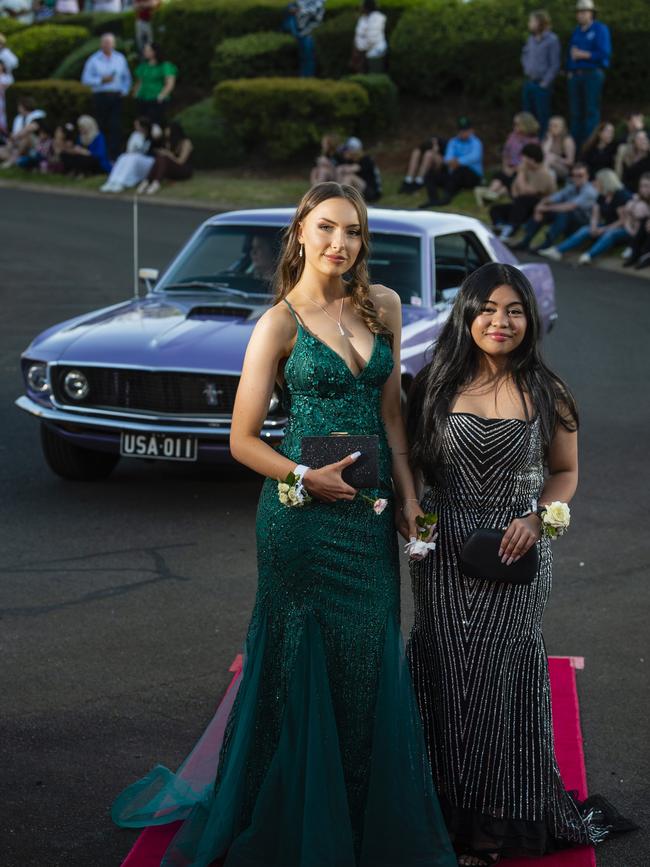 Taylah Alchin (left) and Caren Rodriguez arrive at Harristown State High School formal at Highfields Cultural Centre, Friday, November 18, 2022. Picture: Kevin Farmer