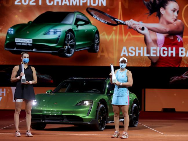 STUTTGART, GERMANY - APRIL 25: Ashleigh Barty (R) of Australia  celebrates with the trophy after winning the final match against Aryna Sabalenka of Belarus during day 9 of the Porsche Tennis Grand Prix at Porsche Arena on April 25, 2021 in Stuttgart, Germany. Sporting arenas around Germany remain under strict restrictions due to the Coronavirus Pandemic as Government social distancing laws prohibit fans inside venues resulting in games being played behind closed doors. (Photo by Alex Grimm/Getty Images)