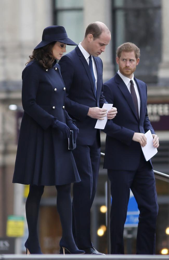 Kate Middleton with Prince William and Prince Harry braving the cold in a navy coat. Image: / AFP PHOTO / Tolga AKMEN.