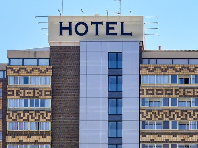 Alicante, Spain - October 29, 2022: Upper facade of the Hotel Maya building. The building has several windows, and a big 'hotel' sign is at the top.