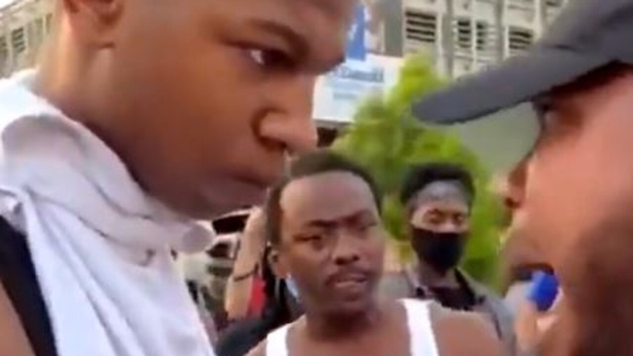 A teenage boy listens to an older man talk about the protests. Picture: Twitter