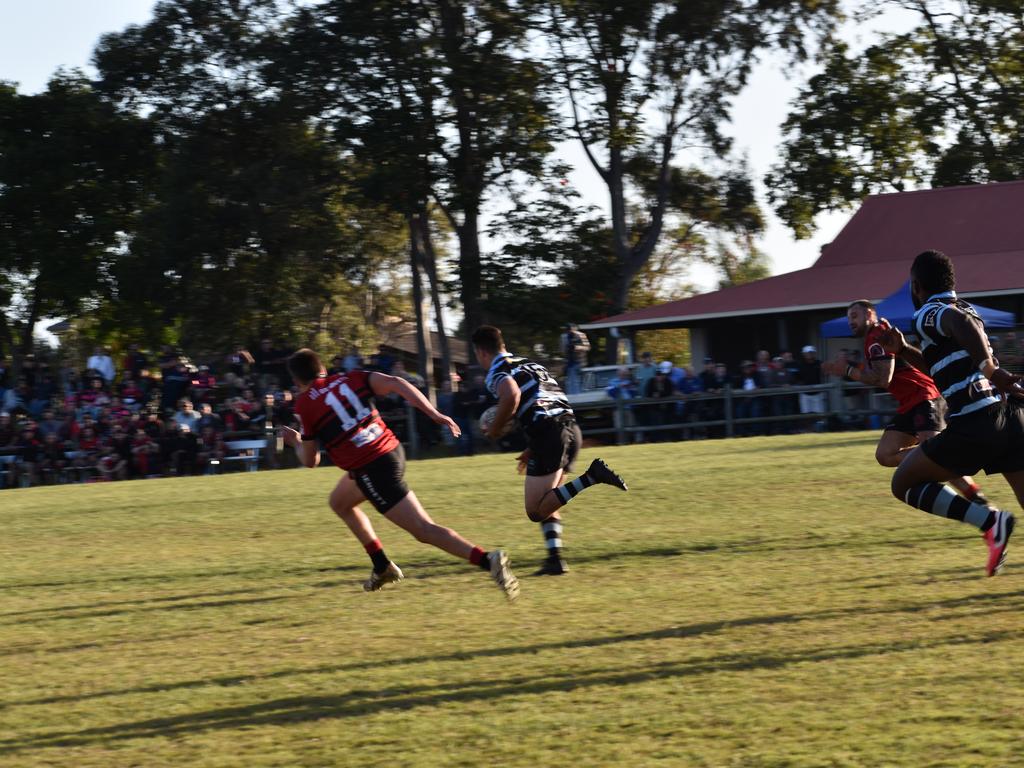 Wollongbar player Bodi Smith chases down Tom Watson of Ballina