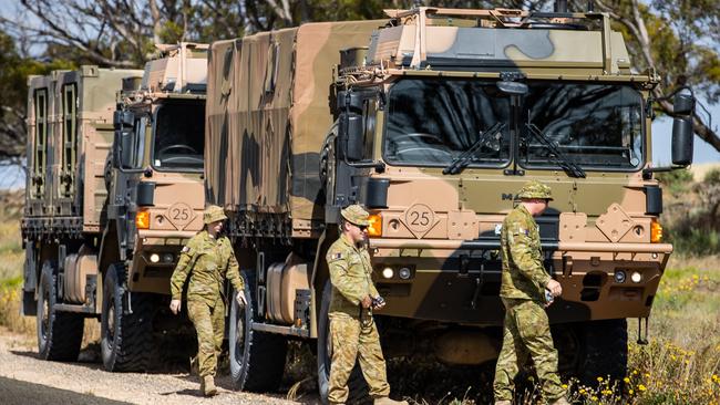 Australia Defence Force personnel with two of the high clearance vehicles deployed for the Murray River floods. Picture: Tom Huntley