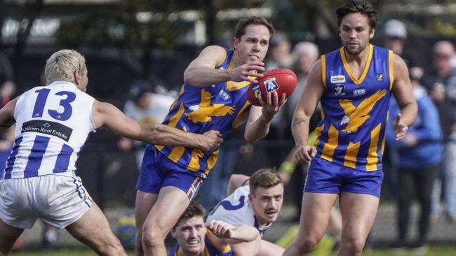 MPNFL: Somerville’s Lachlan Williams fires out a handball. Picture: Valeriu Campan