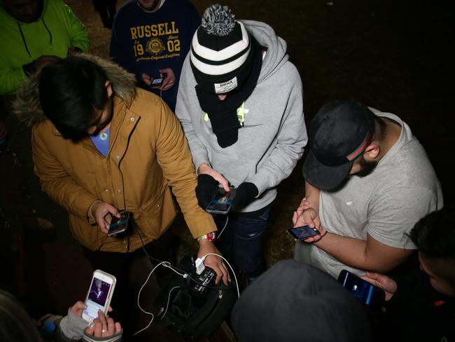 Players out searching for Pokemon in Rhodes at night. Picture: Bill Hearne