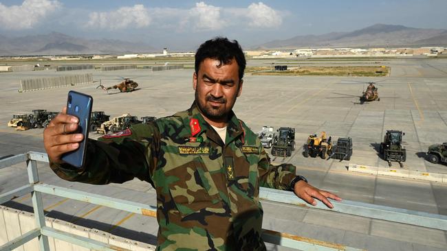 An Afghan National Army soldier takes a selfie with his mobile phone inside the Bagram US air base in July after all US and NATO troops left. Picture: Wakil Kohsar/AFP