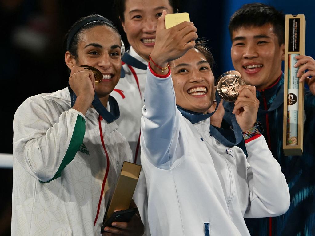 Imane Khelif, silver medallist Yang Liu, and bronze medallists Janjaem Suwannapheng and Chen Nien-chin pose for a selfie on the podium. Picture: AFP