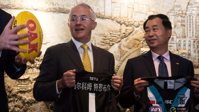 Gui Guojie with Prime Minister Malcolm Turnbull in China last week Mr Goujie signed on to sponsor Port Adelaide Football Club. AFP PHOTO / JOHANNES EISEL