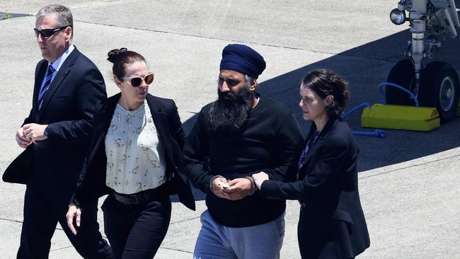 Queensland Police officers and detectives with Rajwinder Singh at Cairns Airport in 2022. Picture: Brendan Radke