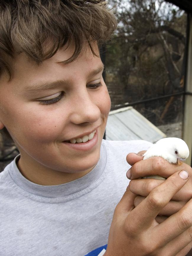 Jay Russell with Lucky the budgie who survived the fire at Humevale. 