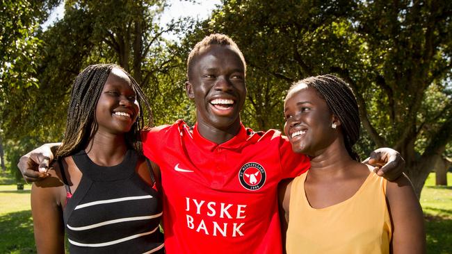 Bor Mabil, right, with her Socceroo brother Awer Mabil, centre, and cousin Abiei Ajak during his time playing for Adelaide United in 2015. Picture: James Elsby.